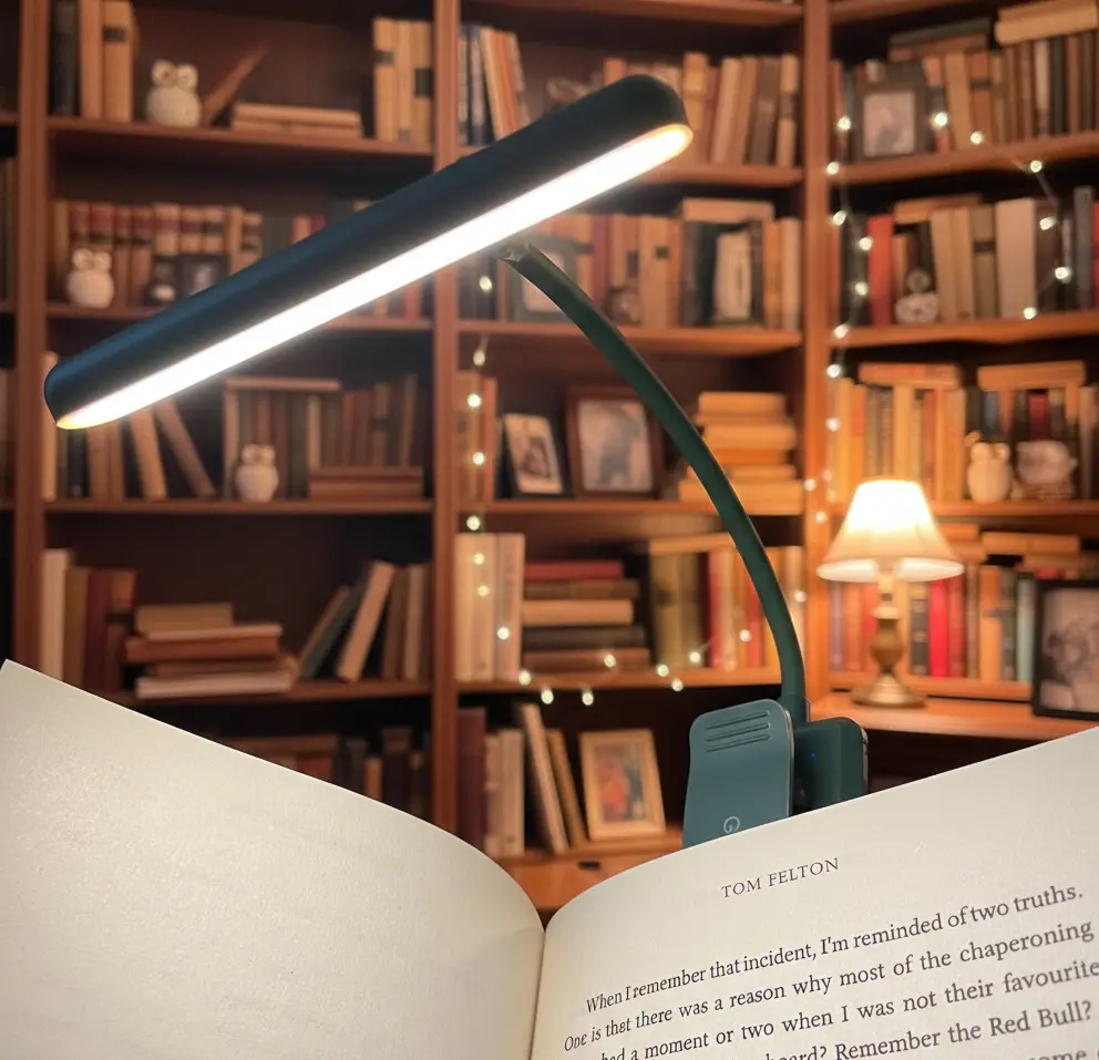 Gritin clip-on book light attached to book with flexible gooseneck and adjustable LED panel